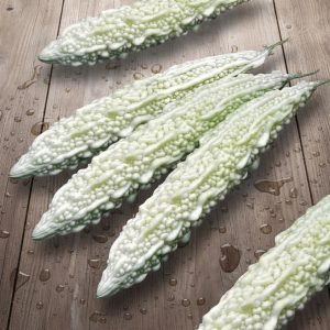 bitter gourd white fairy seeds with pale white bitter melon fruit, momordica charantia white bitter gourd close-up fresh harvest